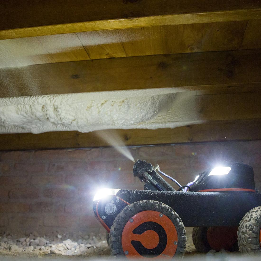 Q-Bot robot spraying foam insulation under floor